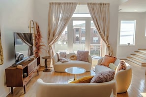 Living Room: Welcome to our haven of warmth and joy! Dive into the heart of relaxation in our cozy living room, where every corner invites laughter and cherished moments with loved ones.