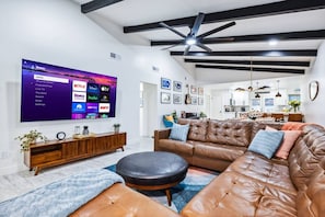 Cozy up in the stylish living room with Smart TV and ample seating.