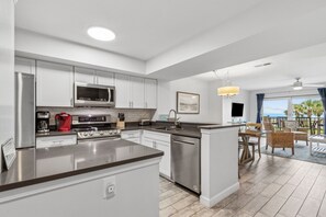 Luxury Fully Equipped Kitchen with Beautiful White Cabinetry, Granite Countertops, and Stainless Steel Appliances