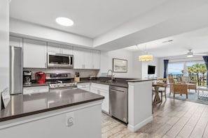 Luxury Fully Equipped Kitchen with Beautiful White Cabinetry, Granite Countertops, and Stainless Steel Appliances