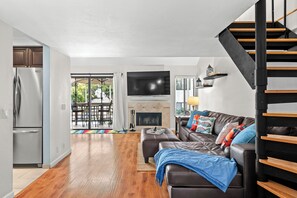 Relax and unwind in the cozy living room, complete with a warm fireplace and comfortable seating.