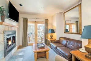 Living room 1: Main floor, gas fireplace, Smart TV, balcony access, pull-out sofa