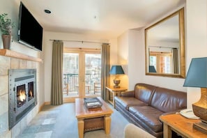 Living room 1: Main floor, gas fireplace, Smart TV, balcony access, pull-out sofa