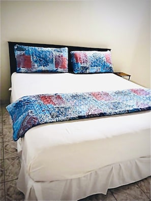 Relax and unwind in the spacious king-size bed with soft linens & air-condition.