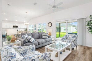Open Concept: Living Room, Dining and Kitchen with an Abundance of Windows for Natural Light. Screened-in Lanai off of the Living Room