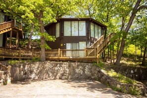 This modern elevated home offers a unique "treetop" living experience, blending seamlessly with the surrounding lush natural landscape. Multiple large windows allow for abundant natural light and scenic views, making this a bright and inviting retreat.