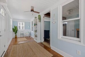 Escape to our North Wildwood haven! This bright and airy sunroom welcomes you with its coastal charm, featuring soothing blue walls, natural wood floors, and a delightful nautical-themed decor. Perfect for relaxing after a day at the beach!