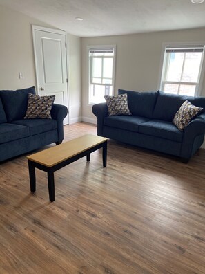 Bright and comfy living room with smart TV, AC and Wi-Fi.