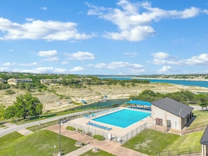 Community pool with a view of Lake Travis in the background
