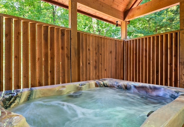 Slip into total relaxation with this private hot tub tucked beneath a covered deck—ideal for unwinding after a day of adventure.