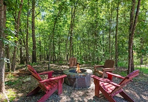 Gather ‘round the fire pit surrounded by towering trees and comfy red Adirondack chairs—s’mores and stories highly recommended!