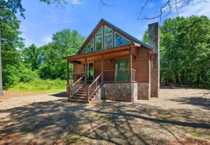 Framed by forest, this wide-angle view shows just how charming and private your cabin truly is—welcome to your woodland escape.