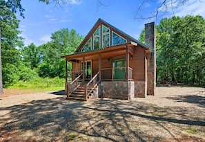 Framed by forest, this wide-angle view shows just how charming and private your cabin truly is—welcome to your woodland escape.
