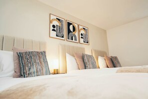 Spacious master bedroom with 3 single beds and soft bedding