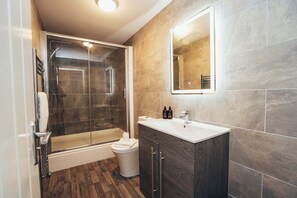 Bathroom with large glass-enclosed shower and modern fixtures