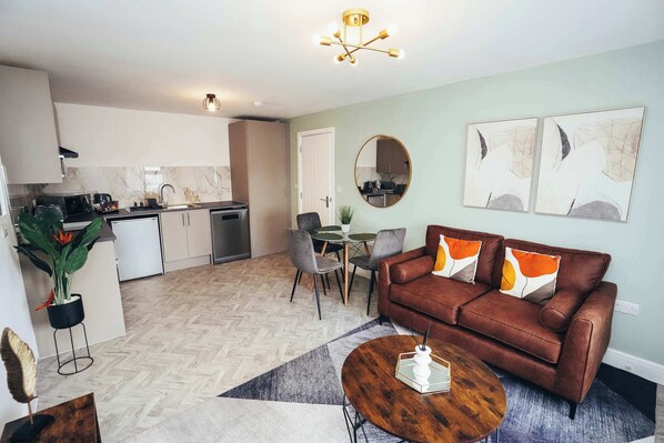 Comfortable lounge with soft sofa, scatter cushions, and neutral decor