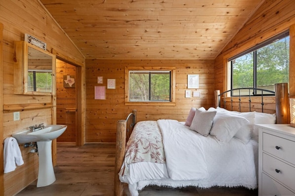Perfect for families or small groups, this inviting room offers two queen beds, peaceful lake views, and a private entrance for added convenience.