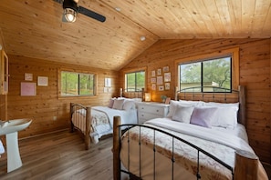 This bright and cozy room with two queen beds is ideal for group getaways. Enjoy relaxing views, warm wood tones, and a peaceful Hill Country vibe.