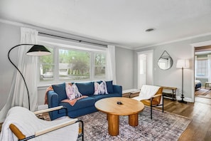Sitting area with soft rug & natural light.
