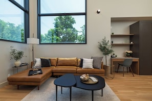Living room with lots of seating & natural light.
