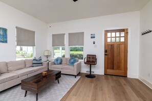 Relax in this open-concept living room featuring a spacious L-shaped sectional.