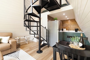 Spiral staircase leads to the king bed upstairs, kitchen table for 2 and fully stocked kitchen