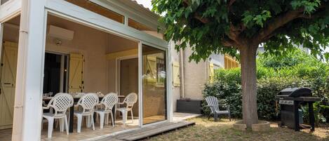 Outdoor area sheltered from view with large veranda and gas barbecue