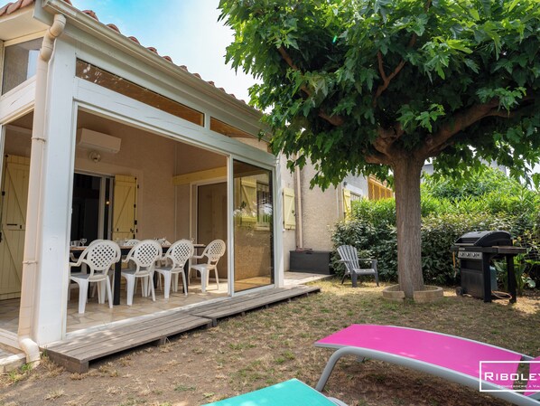 Outdoor area sheltered from view with large veranda and gas barbecue 