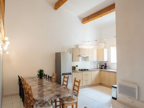 Large air-conditioned living room opening onto the fully equipped kitchen