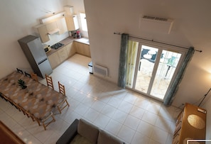 Large air-conditioned living room opening onto the fully equipped kitchen