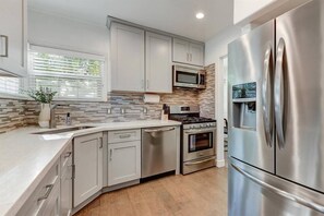 Fully Equipped kitchen, with refrigerator, gas stove, microwave and dishwasher.  All necessities to cook are present! 
