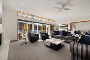 Newly renovated lakefront living room with stylish wet bar, perfect for entertaining in Queenstown.