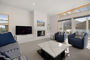 Cozy gas fireplace and unlimited high-speed WiFi in this modern Queenstown villa’s living space.