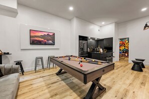 Lounge area with a kitchenette, bistro seating, and a pool table.