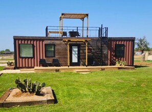 Luxury container home Fredericksburg TX with rooftop deck pergola - unique railway-themed rental in Texas Hill Country wine country, minutes from 50+ wineries and downtown attractions.