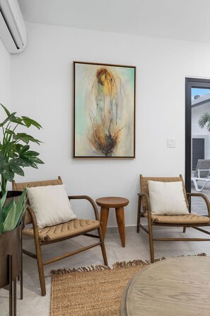 Chic reading corner with natural light, earthy textures, and a calm, modern vibe.