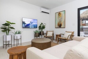 Bright and cozy living room with A/C, smart TV, and plenty of space to unwind after a day in the sun.
