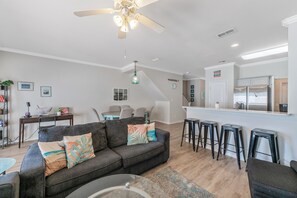 This comfy space is made for gathering, with soft seating, a big-screen TV, and plenty of room to stretch out