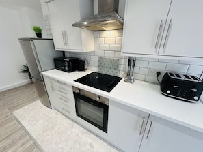 Fully equipped kitchen with cooker and hop, washing machine, toaster, kettle,