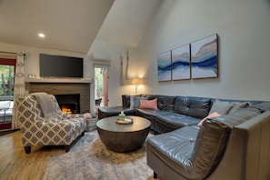 Large sectional couch and electric fireplace.