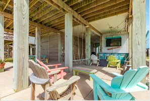 Downstairs space - bar, refrigerator, sink TV, swings and amazing beach view