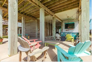 Downstairs space - bar, refrigerator, sink TV, swings and amazing beach view