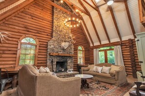 Living area with ample seating, TV, and gas fireplace 