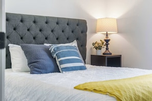 The primary suite boasts a plush queen bed & ensuite bath