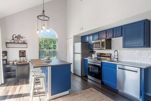 The airy kitchen offers ample space & every home comfort