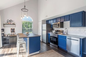 The airy kitchen offers ample space & every home comfort