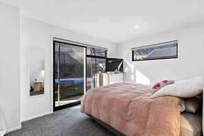 Bright master bedroom with mountain views and patio access (furniture to be updated post-June 16th)