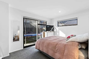 Bright master bedroom with mountain views and patio access (furniture to be updated post-June 16th)