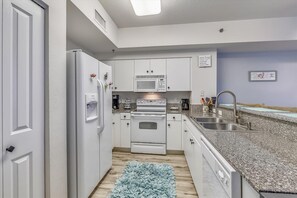 Kitchen with granite counter tops and large fridge/freezer