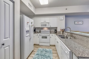 Kitchen with granite counter tops and large fridge/freezer
